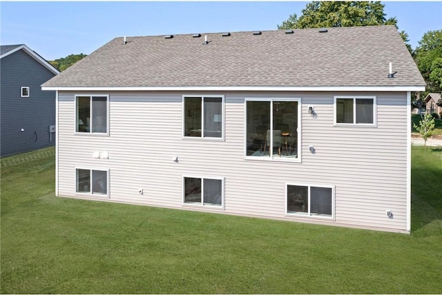 rear view of house with a lawn