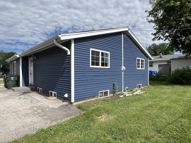 view of side of property with a yard