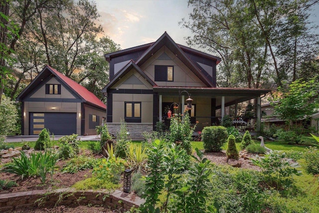 view of front facade featuring covered porch and a garage