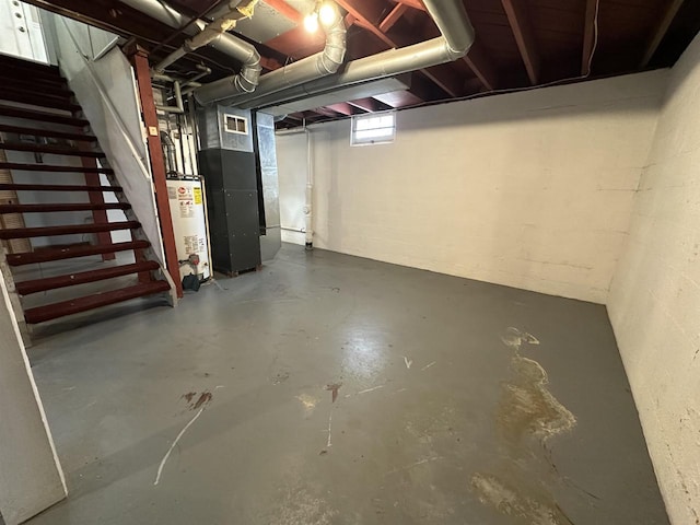 basement featuring visible vents, water heater, stairway, and heating unit