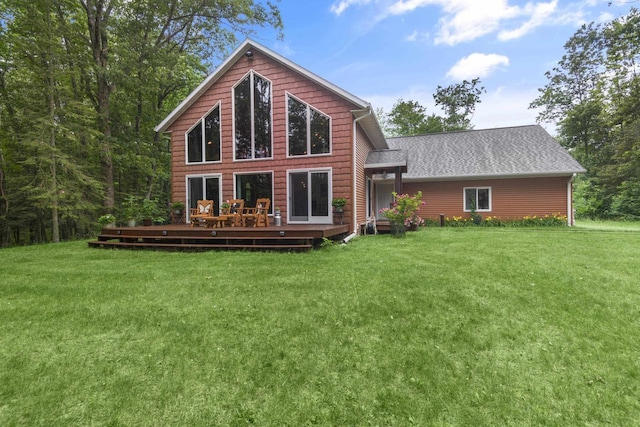 rear view of property featuring a yard and a deck