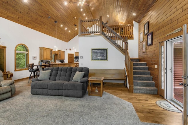 living room with light hardwood / wood-style floors, wood ceiling, and high vaulted ceiling