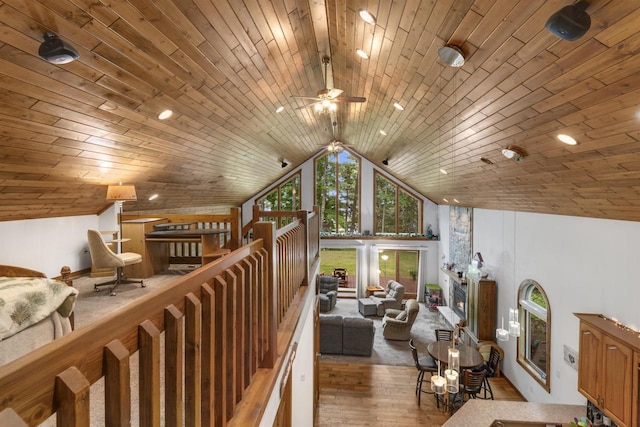 interior space featuring hardwood / wood-style flooring, ceiling fan, wood ceiling, and vaulted ceiling