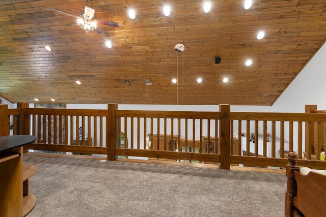 hallway with carpet floors, wooden ceiling, and lofted ceiling