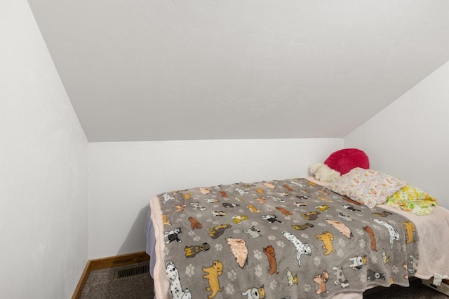 bedroom featuring carpet floors and vaulted ceiling