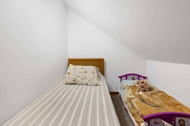 bedroom featuring carpet and lofted ceiling