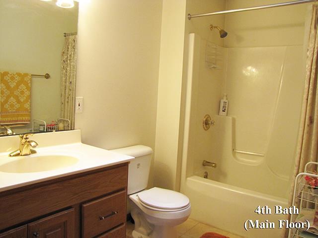 full bathroom with vanity, toilet, and shower / bathtub combination with curtain