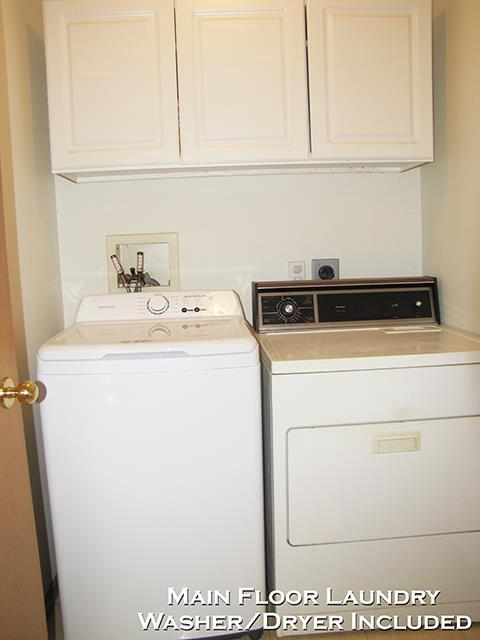 laundry area featuring cabinets and washing machine and dryer