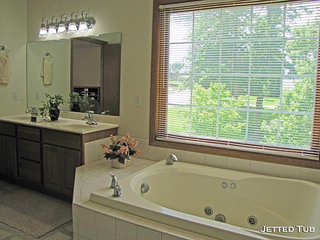 bathroom with vanity, tiled bath, and tile patterned floors