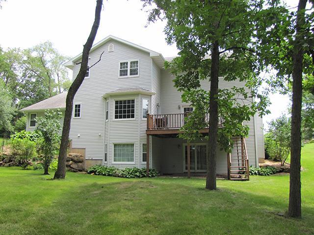 rear view of property with a deck and a yard