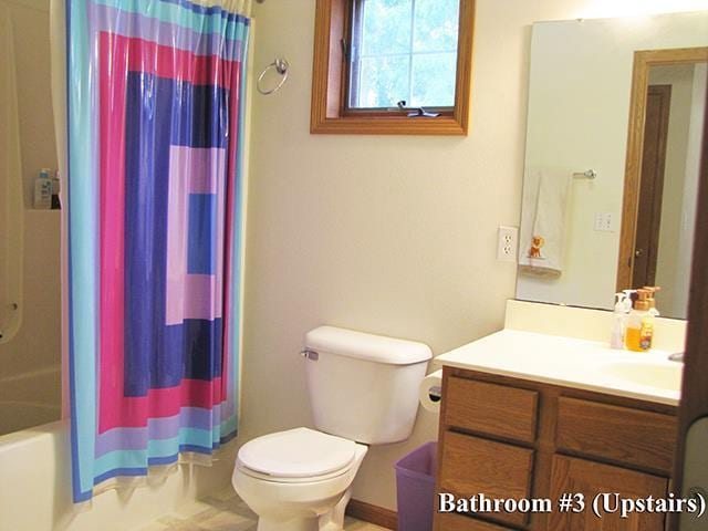 full bathroom with vanity, toilet, and shower / bathtub combination with curtain