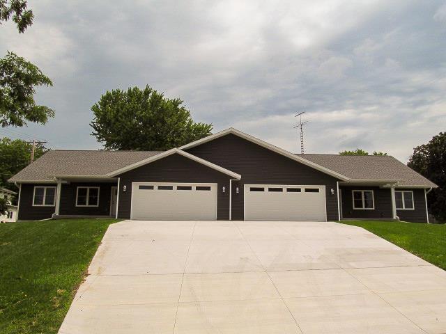 single story home featuring a front yard and a garage