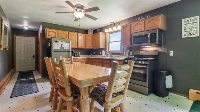 kitchen featuring ceiling fan, sink, and stainless steel appliances