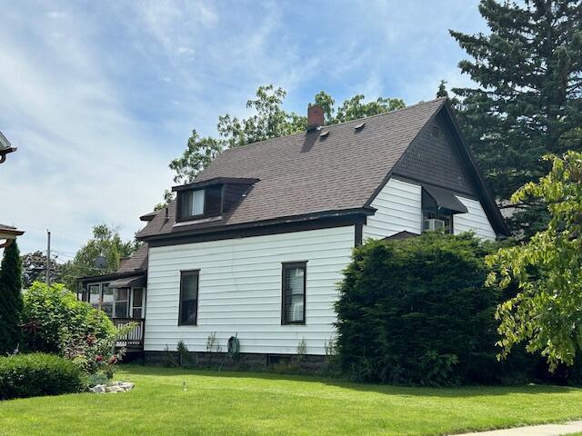 view of side of property with a lawn