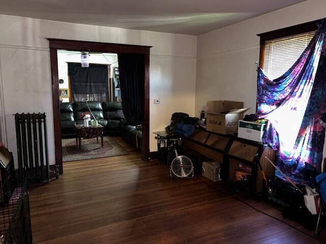 miscellaneous room featuring radiator and hardwood / wood-style floors