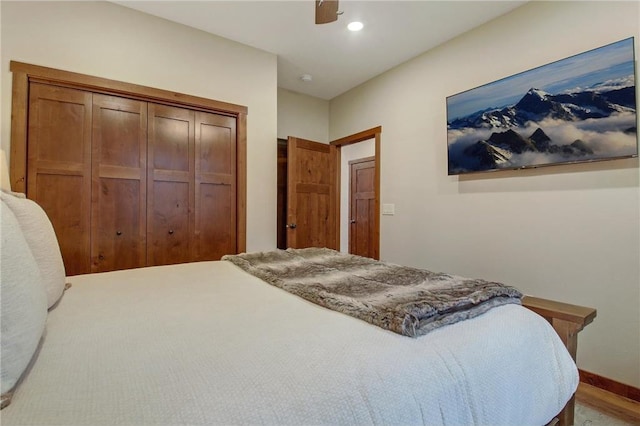 bedroom with ceiling fan and a closet