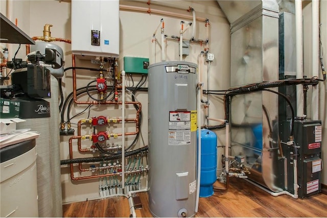 utility room featuring electric water heater and tankless water heater