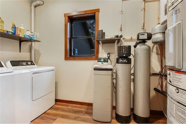 laundry area with washer and clothes dryer and light hardwood / wood-style flooring