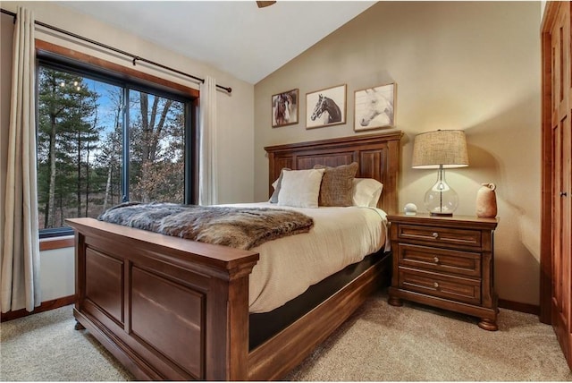 bedroom featuring light carpet, multiple windows, lofted ceiling, and ceiling fan