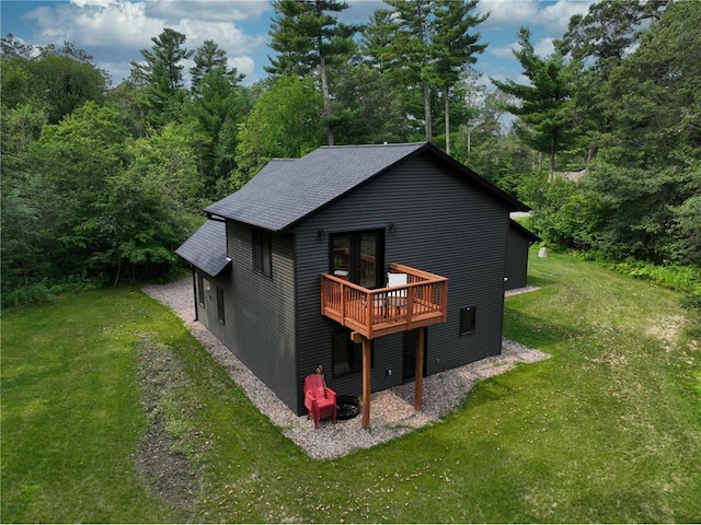 view of property exterior featuring a lawn and a wooden deck