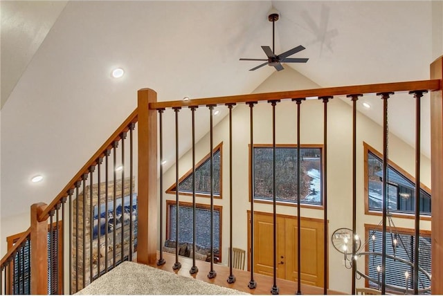 stairs with ceiling fan and vaulted ceiling