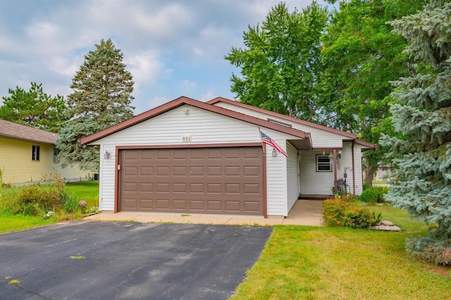 view of front of house featuring a garage and a front lawn