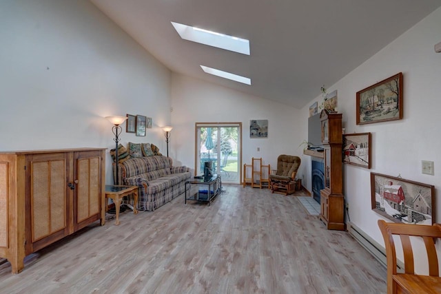 living area with a skylight, high vaulted ceiling, and light hardwood / wood-style flooring