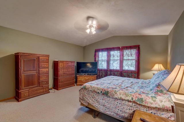 bedroom with vaulted ceiling, light colored carpet, and ceiling fan