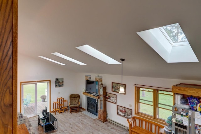 living room featuring light hardwood / wood-style flooring, a healthy amount of sunlight, vaulted ceiling, and a baseboard heating unit