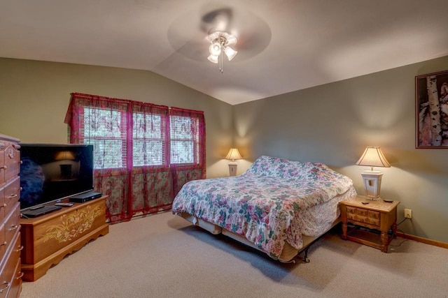 carpeted bedroom featuring ceiling fan and vaulted ceiling