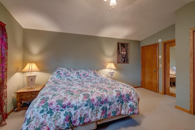 carpeted bedroom featuring ceiling fan and vaulted ceiling