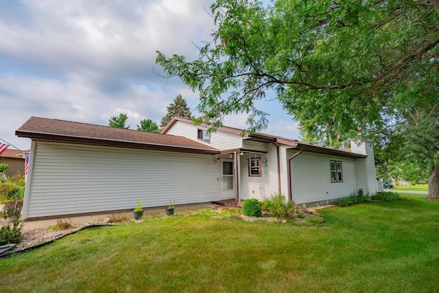 rear view of property featuring a yard