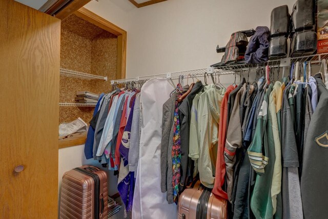 unfurnished bedroom with vaulted ceiling, light carpet, and a closet