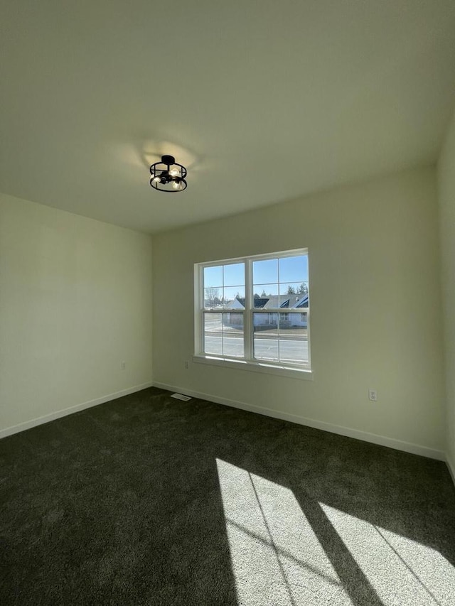 carpeted spare room featuring a water view