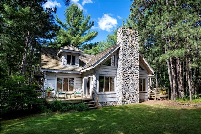 rear view of house featuring a yard