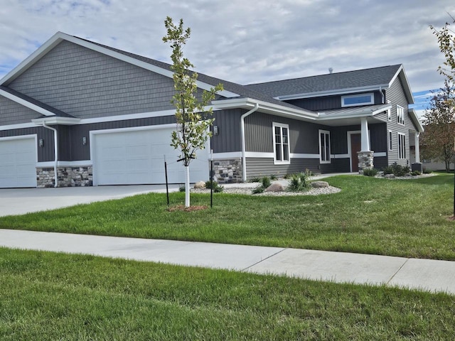 craftsman house with a garage and a front yard