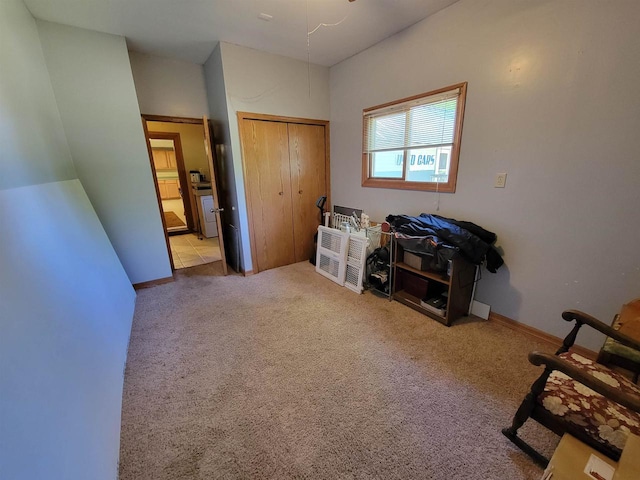 bedroom featuring light carpet and a closet