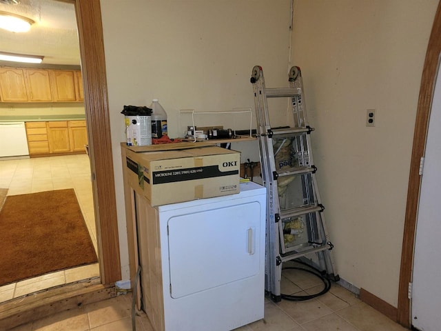 clothes washing area featuring washer / clothes dryer and light tile patterned floors