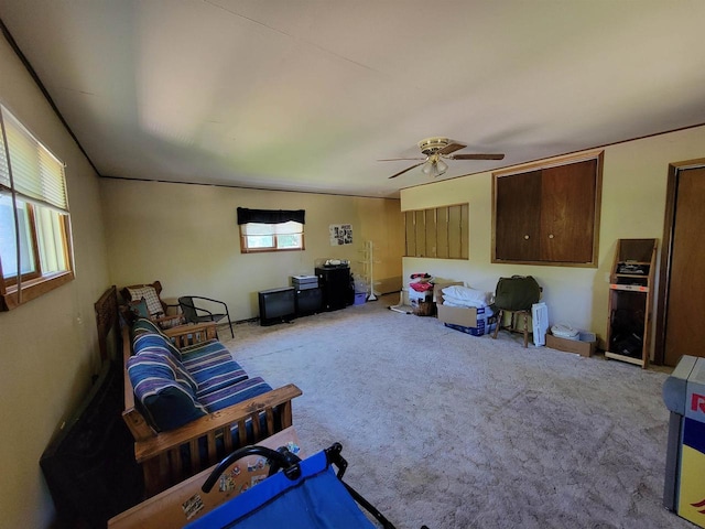 carpeted living room with ceiling fan