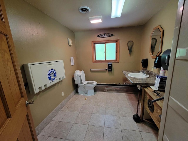 bathroom with tile patterned floors, sink, and toilet