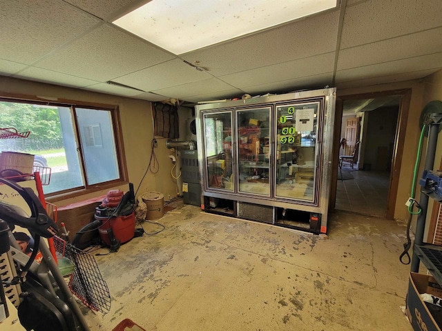 miscellaneous room featuring concrete flooring and a drop ceiling