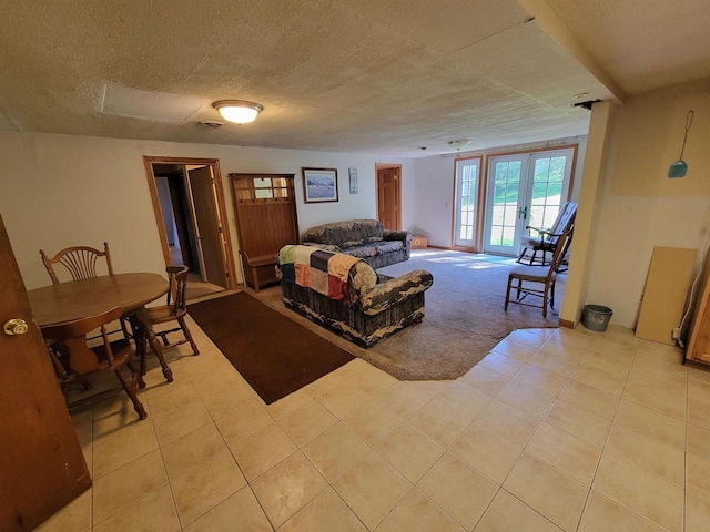 living room with french doors, light colored carpet, and a textured ceiling