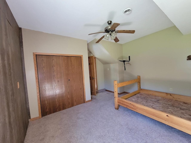 bedroom with light colored carpet, a closet, and ceiling fan