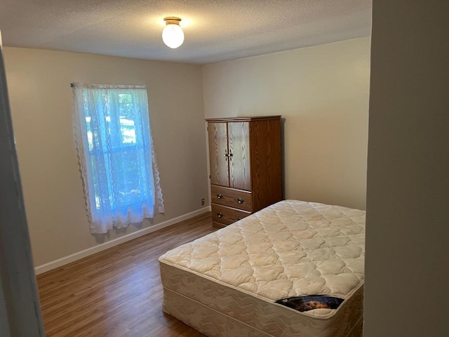 2217 Blackhawk St, Friendship, WI 53934 - bedroom featuring hardwood / wood-style floors and a textured ceiling