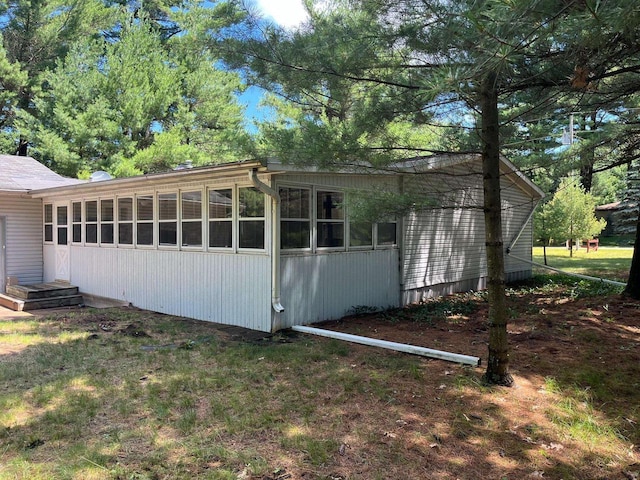 view of home's exterior with a sunroom