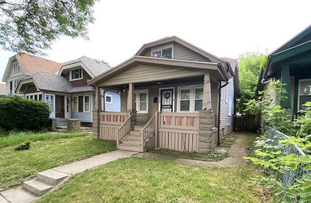 bungalow featuring a front lawn and covered porch