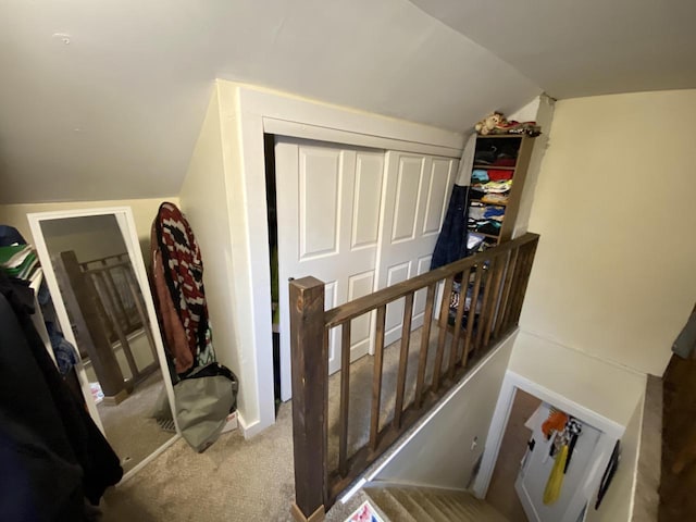 stairway featuring carpet and lofted ceiling