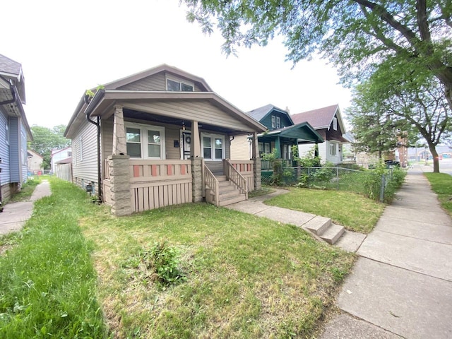 view of front facade with a front yard and a porch