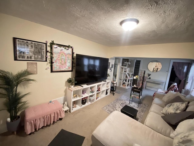 living room featuring carpet and a textured ceiling