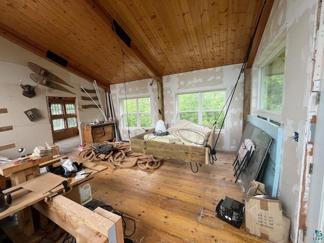 misc room with wood ceiling, a wealth of natural light, lofted ceiling with beams, and light wood-type flooring